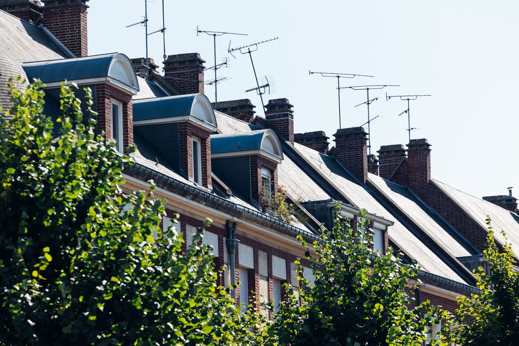 Charming rooftops and antennas in Amiens, showcasing classic French architecture on a sunny day.